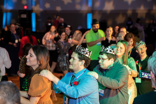 Attendees enjoy dancing in a conga line